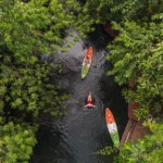 Kayaks on the natural stream among tropical trees at Blu Monkey Pooltara Krabi