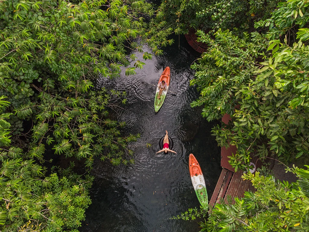 Kayaks on the natural stream among tropical trees at Blu Monkey Pooltara Krabi