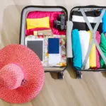Open suitcase with clothes and travel essentials for a warm-weather trip